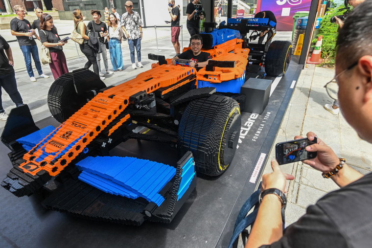 People take pictures of the life-sized LEGO Technic McLaren Formula One race car in Singapore on Sept. 23, 2022.