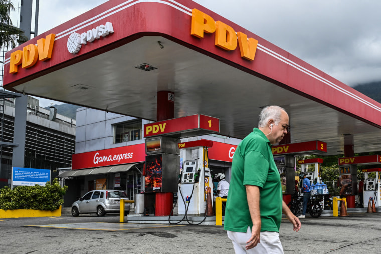 A man walks past a Venezuelan state-owned oil company PDVSA